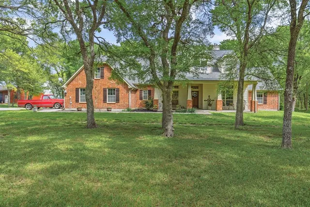 a front view of house with yard and green space