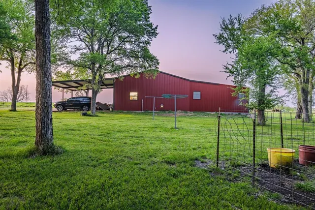 a view of a house with a yard and sitting area