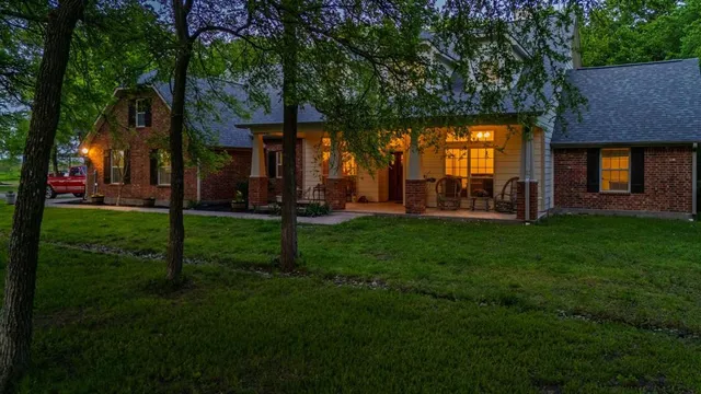 a backyard of a house with lots of green space and fountain