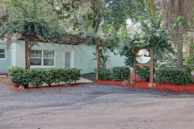 front view of a house with a flower garden