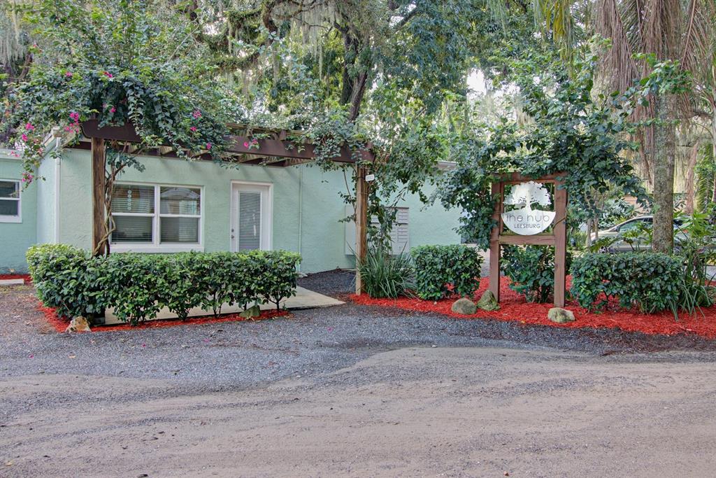 28313 Highway 27 Leesburg, FL 34748 - Photo 1 of 46 front view of a house with a flower garden