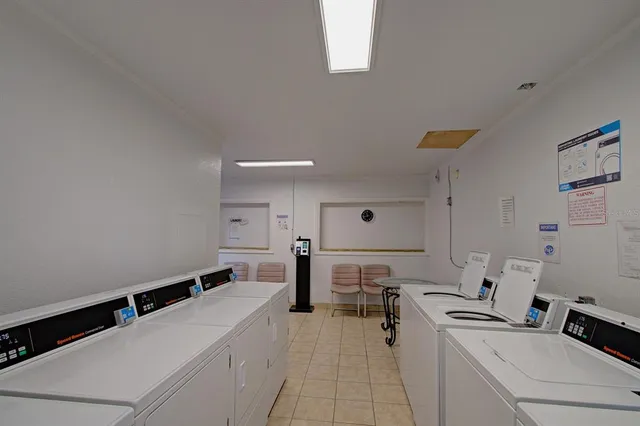 a view of a kitchen with a sink stainless steel appliances and cabinets