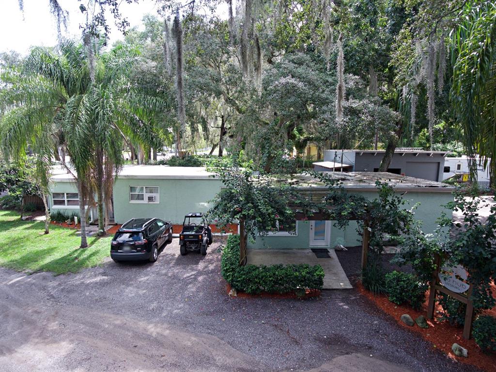 28313 Highway 27 Leesburg, FL 34748 - Photo 35 of 46 a view of a patio with table and chairs potted plants and a large tree