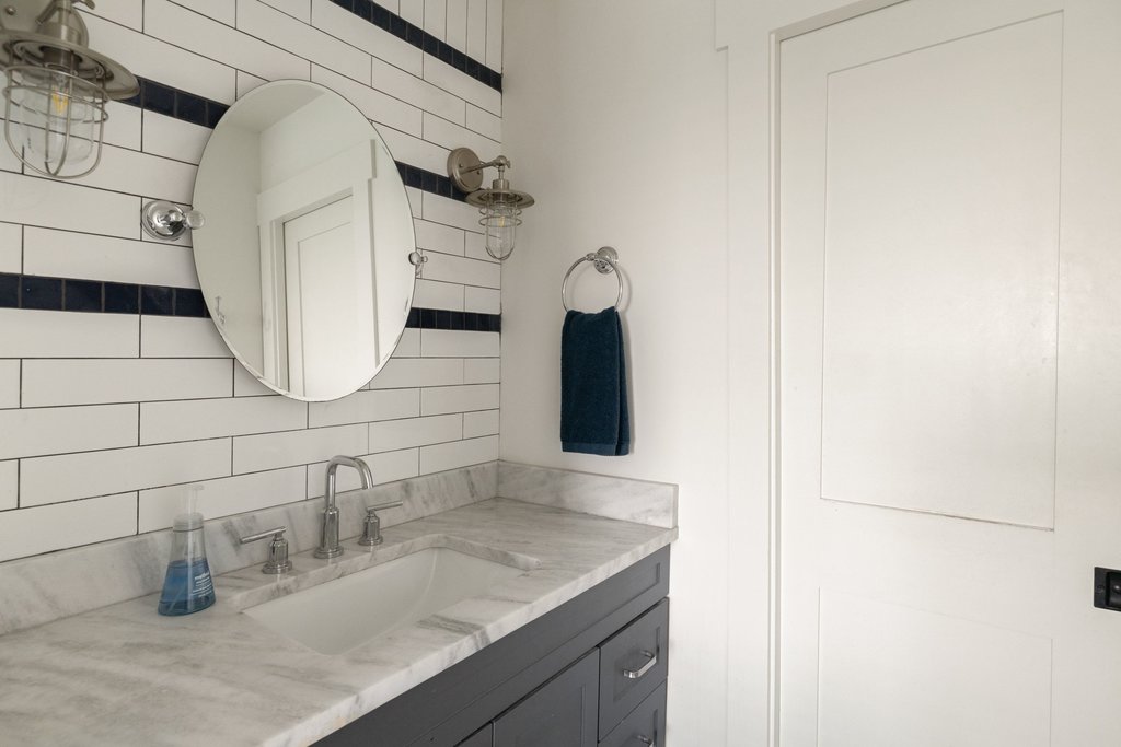 32045 Mirela Ann Road Dripping Springs, TX 78620 - Photo 21 of 30 Elegant stone countertops and timeless tile accents elevate this stylish washroom.