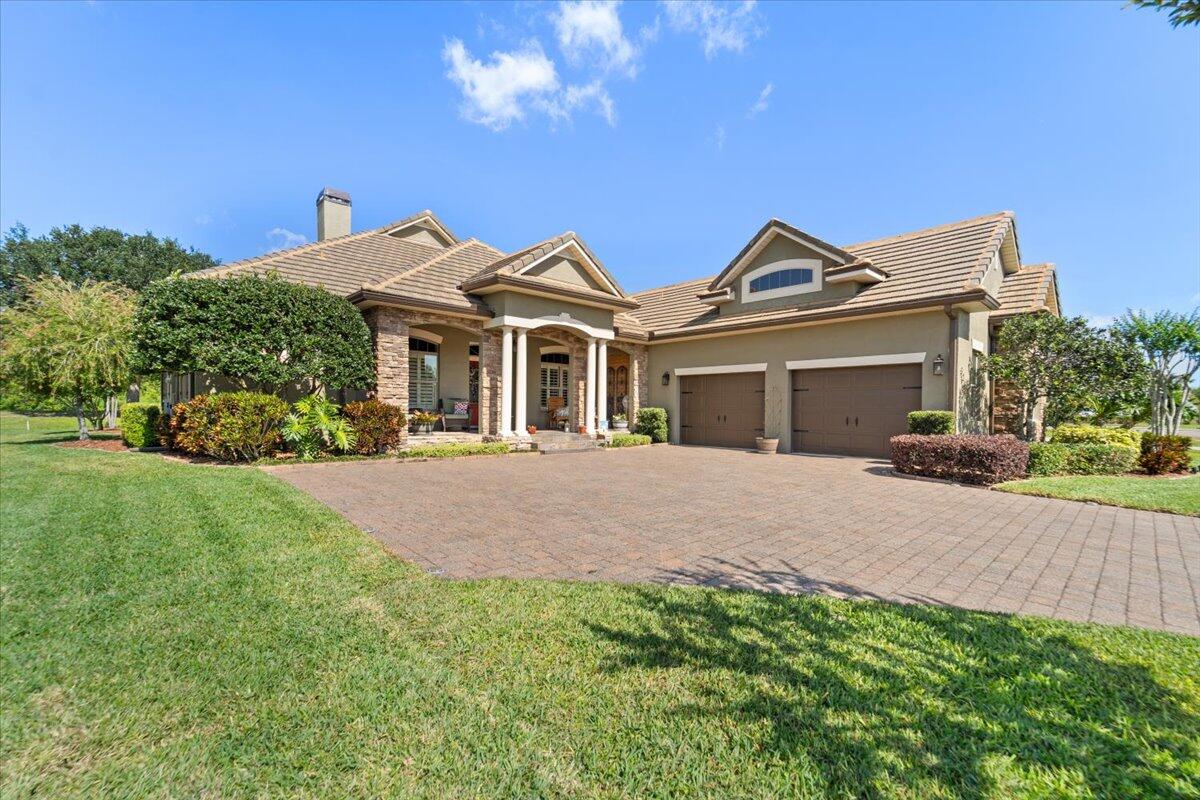 a front view of a house with a garden and plants