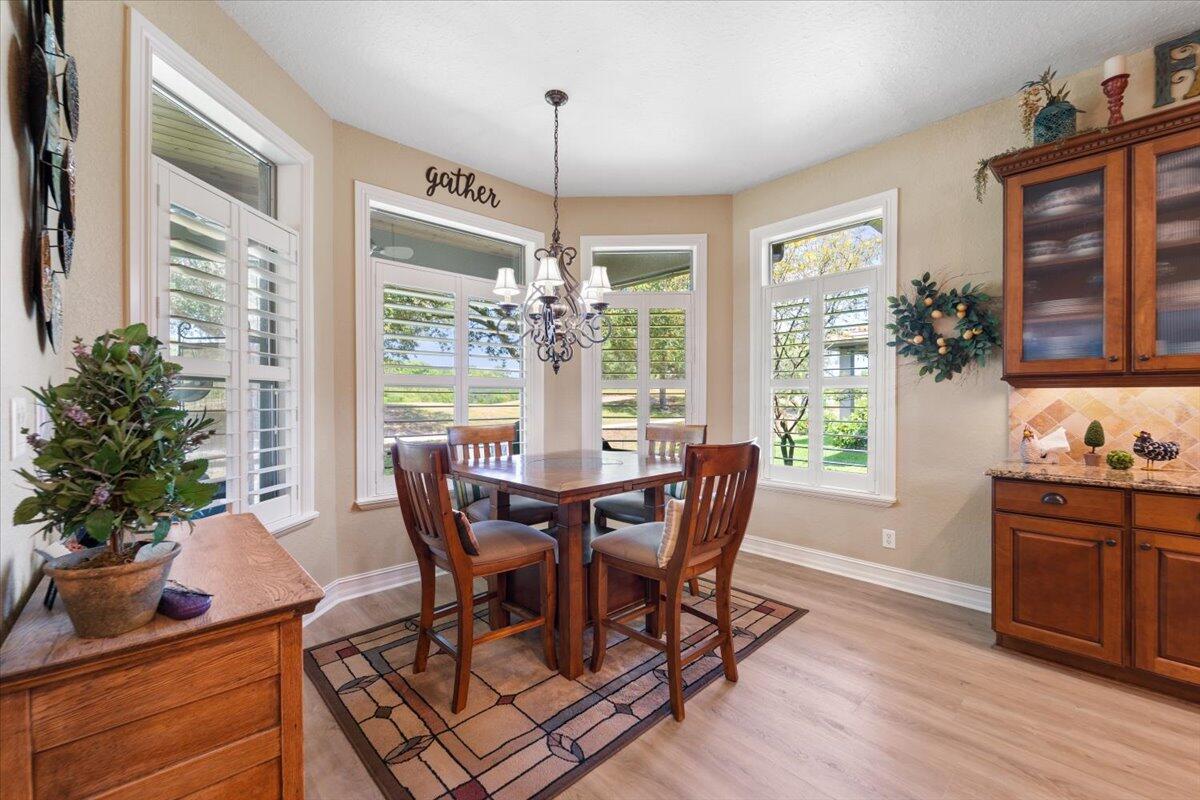 3260 Quantum Place Mims, FL 32754 - Photo 18 of 30 a view of a dining room with furniture window and wooden floor