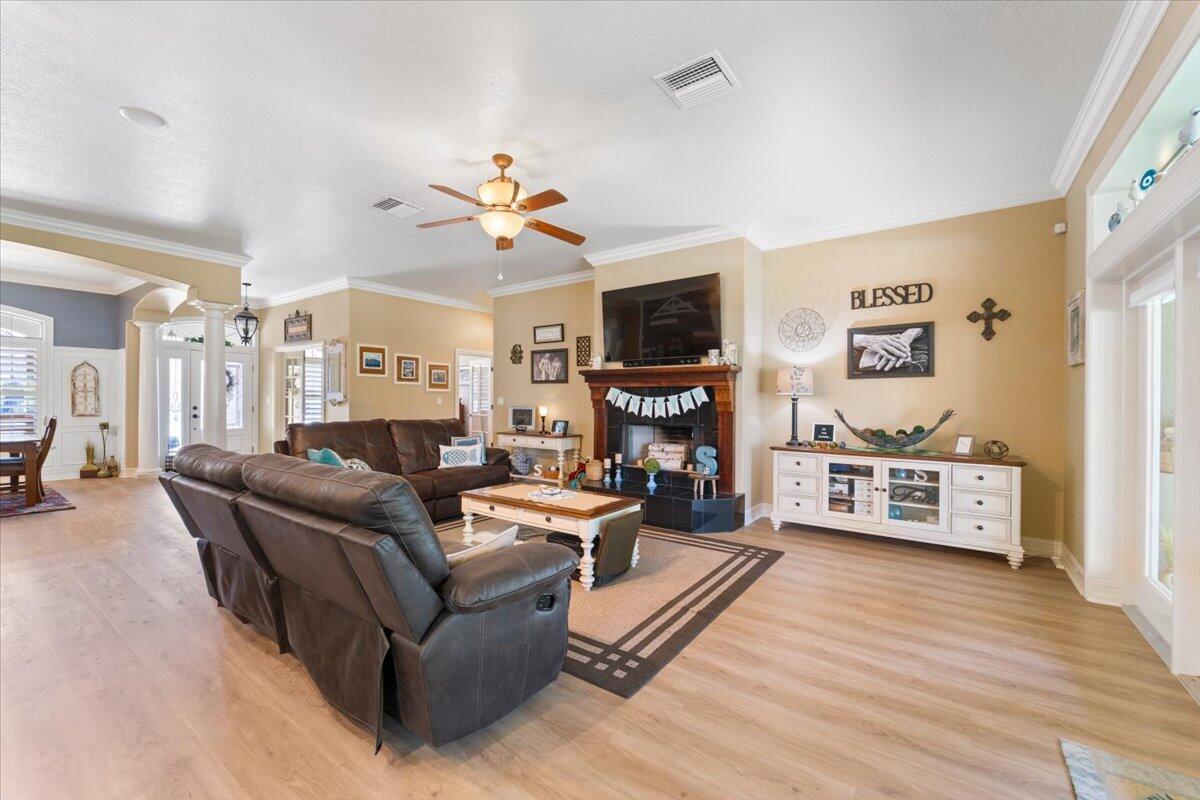 3260 Quantum Place Mims, FL 32754 - Photo 10 of 30 a living room with furniture a flat screen tv and a fireplace