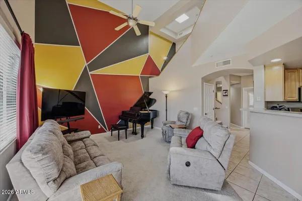 a living room with furniture and kitchen view