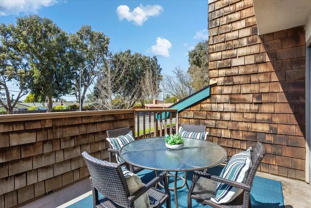 a balcony with table and chairs