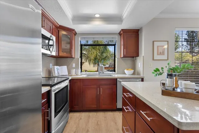 a kitchen with stainless steel appliances granite countertop a sink stove and cabinets
