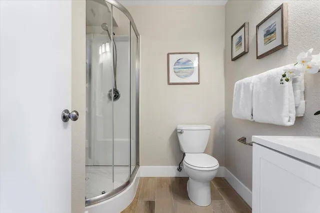 a bathroom with a toilet and a shower
