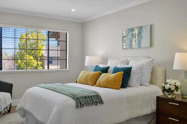 a bedroom with bed and a window