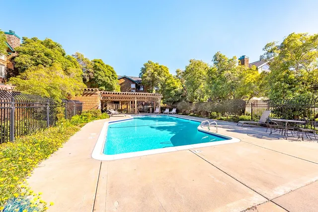 a view of a white house with a swimming pool