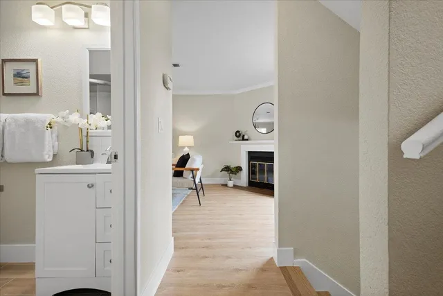 a view of a hallway with a livingroom and a chair