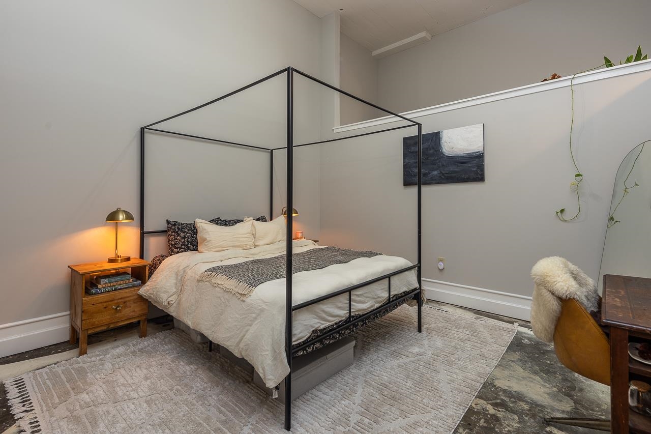 648 Riverside Drive, Unit 213 Memphis, TN 38103 - Photo 12 of 25 a bedroom with a bed and a table in it