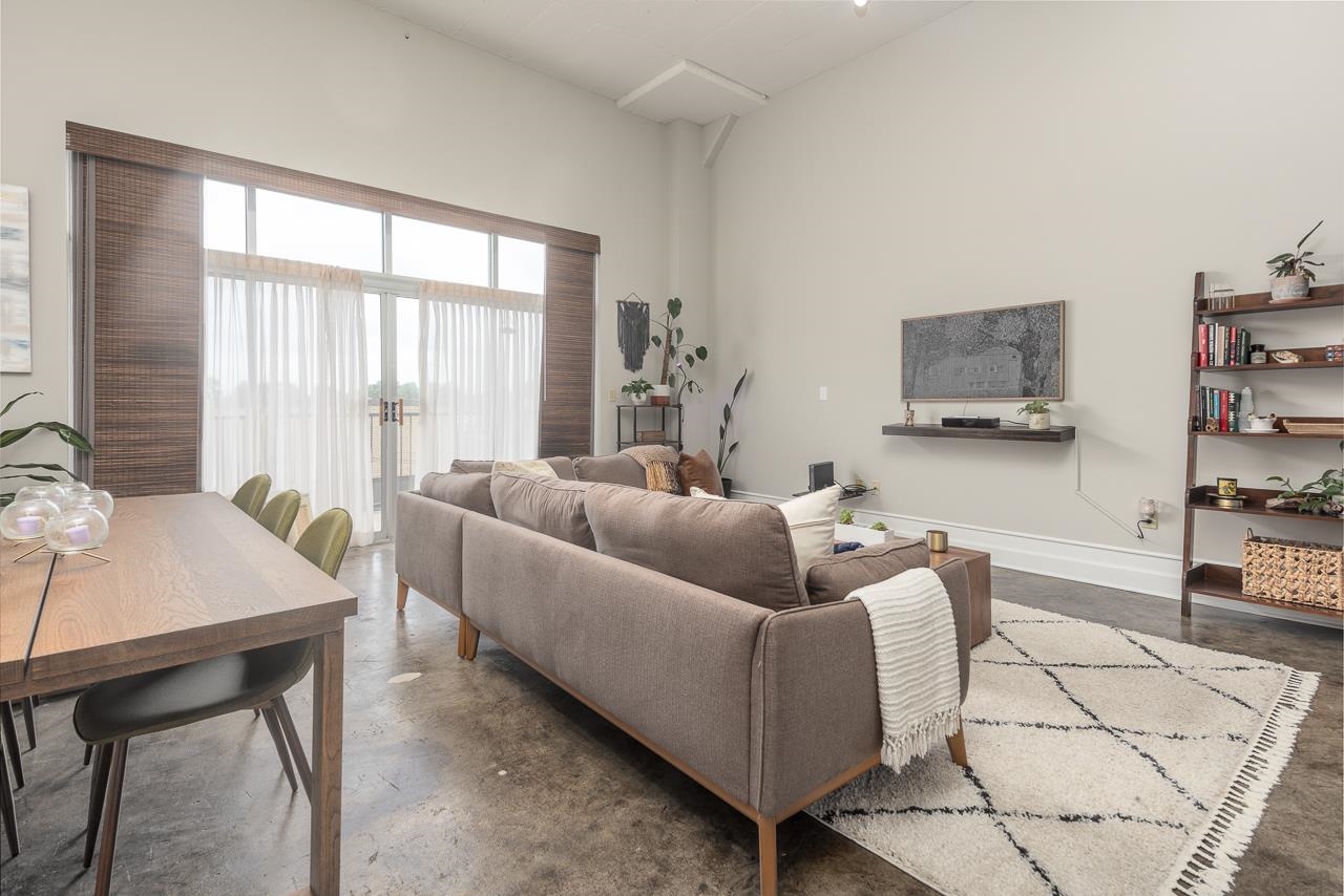 648 Riverside Drive, Unit 213 Memphis, TN 38103 - Photo 2 of 25 a living room with furniture and a flat screen tv