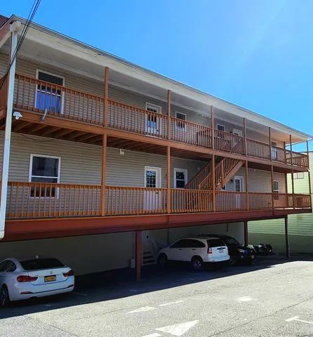 a black car parked in front of a building