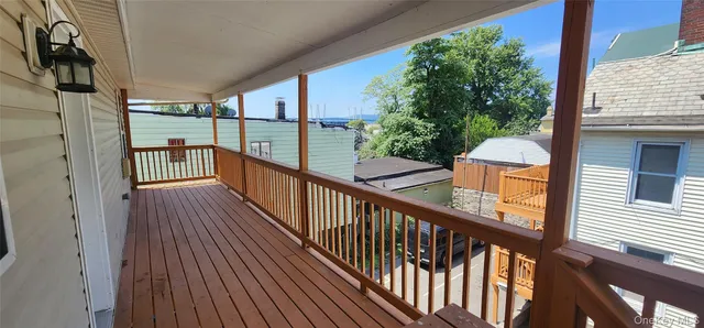 a view of a balcony with wooden floor