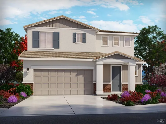 a front view of a house with plants