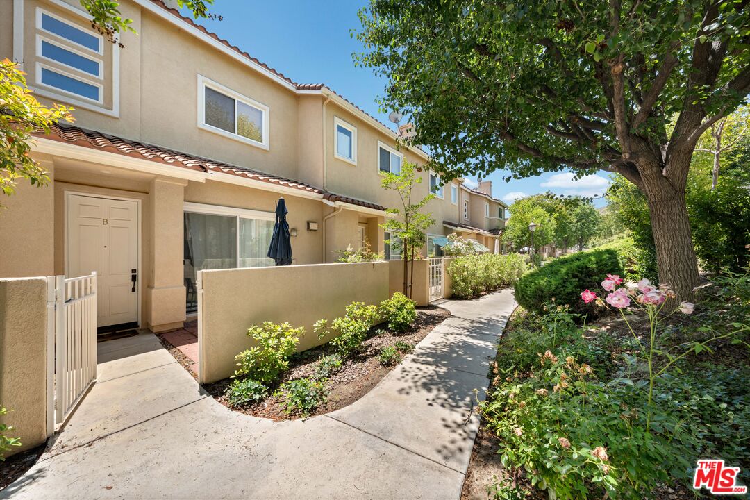 a front view of a house with a yard and flowers