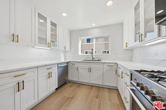 a bathroom with a sink a toilet a mirror and shower