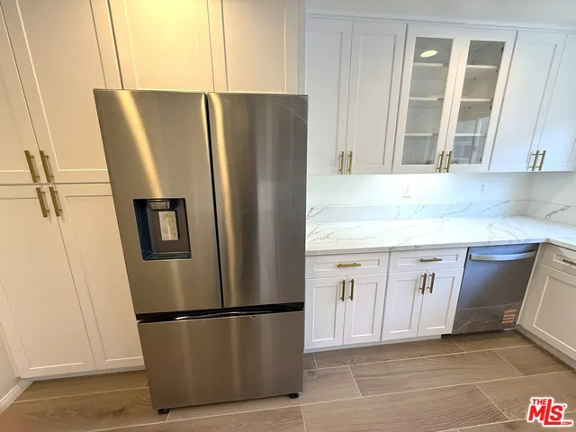 a white refrigerator freezer sitting inside of a kitchen
