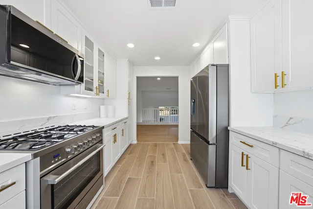 a view of a hallway with wooden floor and a window