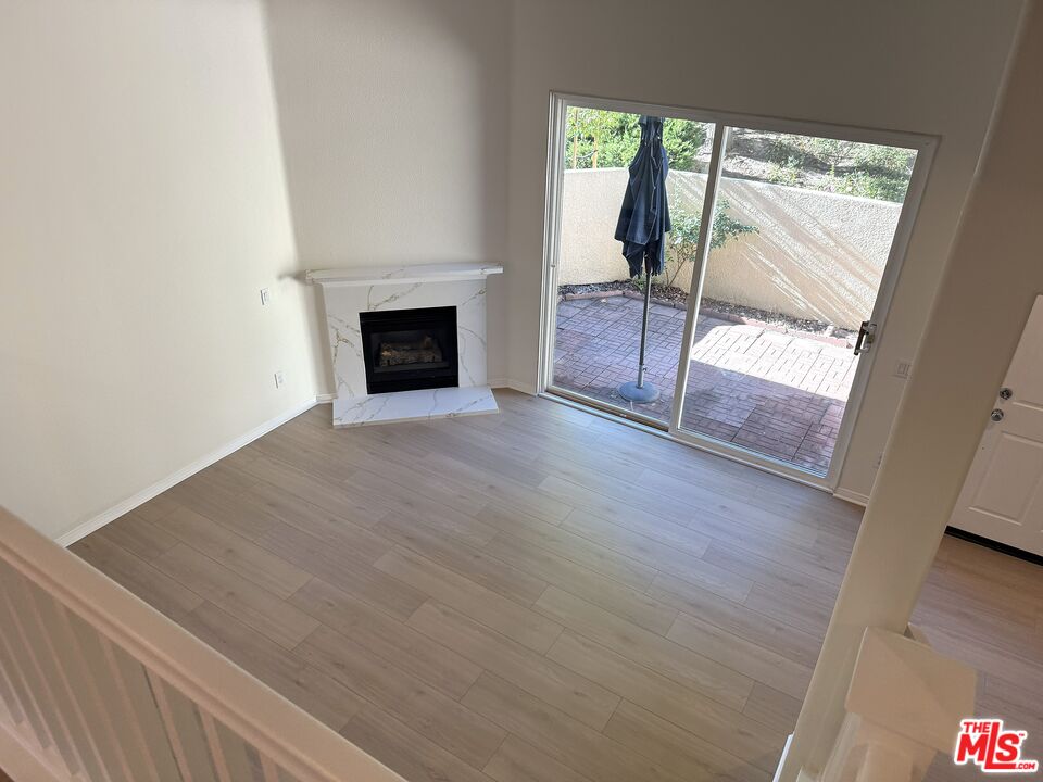 25715 Wagner Way, Unit B Stevenson Ranch, CA 91381 - Photo 14 of 24 a view of an empty room with wooden floor and a window