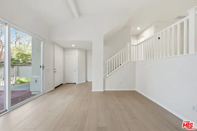 a bathroom with a granite countertop sink a mirror and a shower