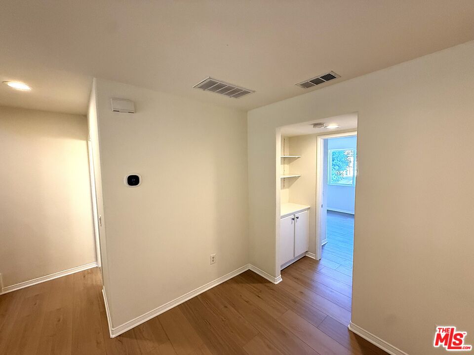 25715 Wagner Way, Unit B Stevenson Ranch, CA 91381 - Photo 17 of 24 a view of an empty room with wooden floor and a window