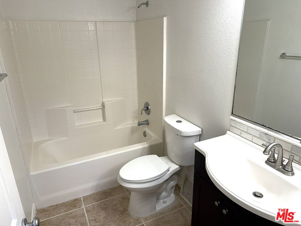 25715 Wagner Way, Unit B Stevenson Ranch, CA 91381 - Photo 19 of 24 a white toilet sitting next to a bathroom sink
