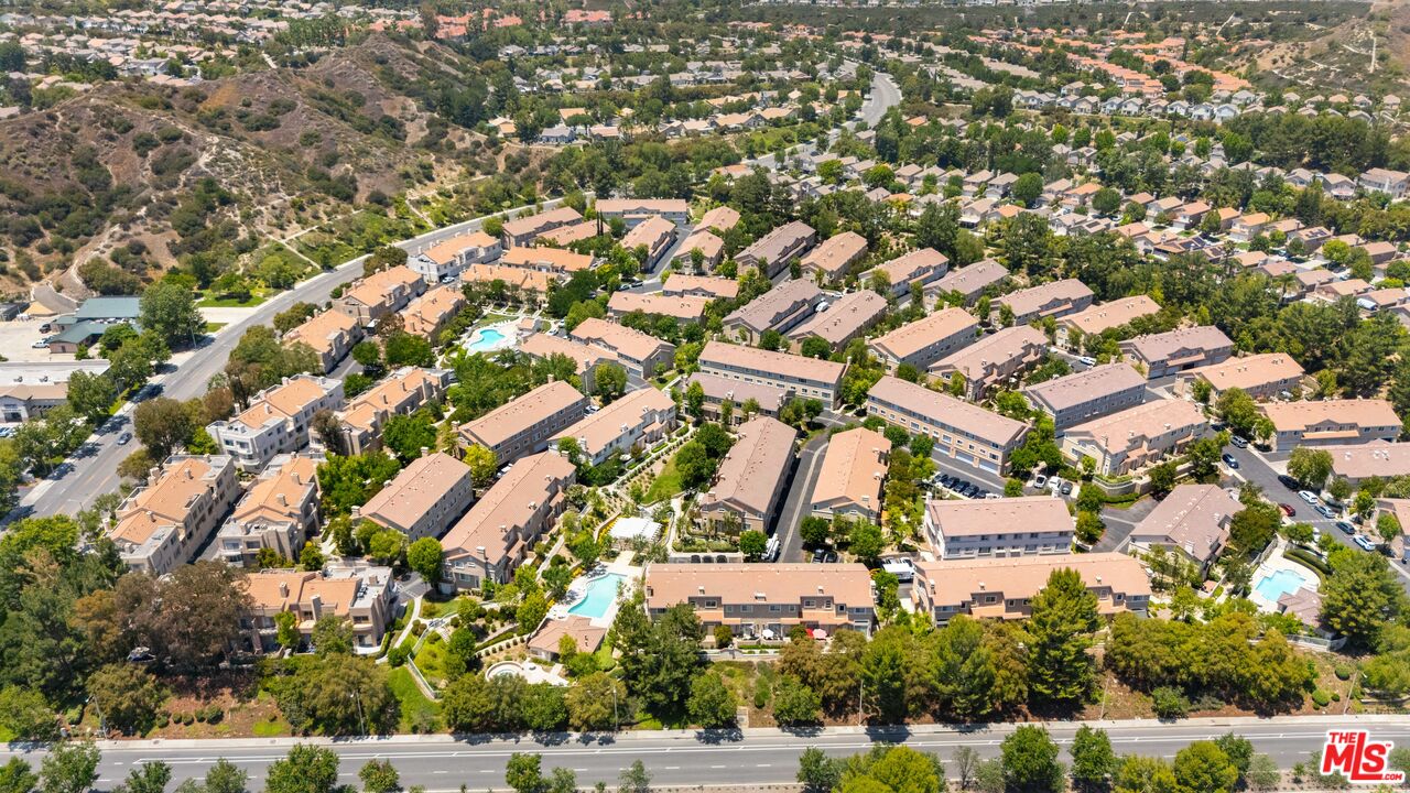 25715 Wagner Way, Unit B Stevenson Ranch, CA 91381 - Photo 2 of 24 an aerial view of residential houses with outdoor space and trees