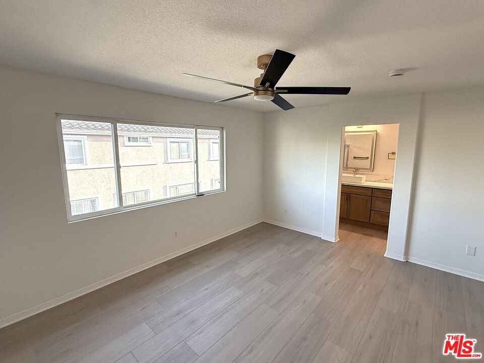 25715 Wagner Way, Unit B Stevenson Ranch, CA 91381 - Photo 23 of 24 wooden floor in an empty room with a window