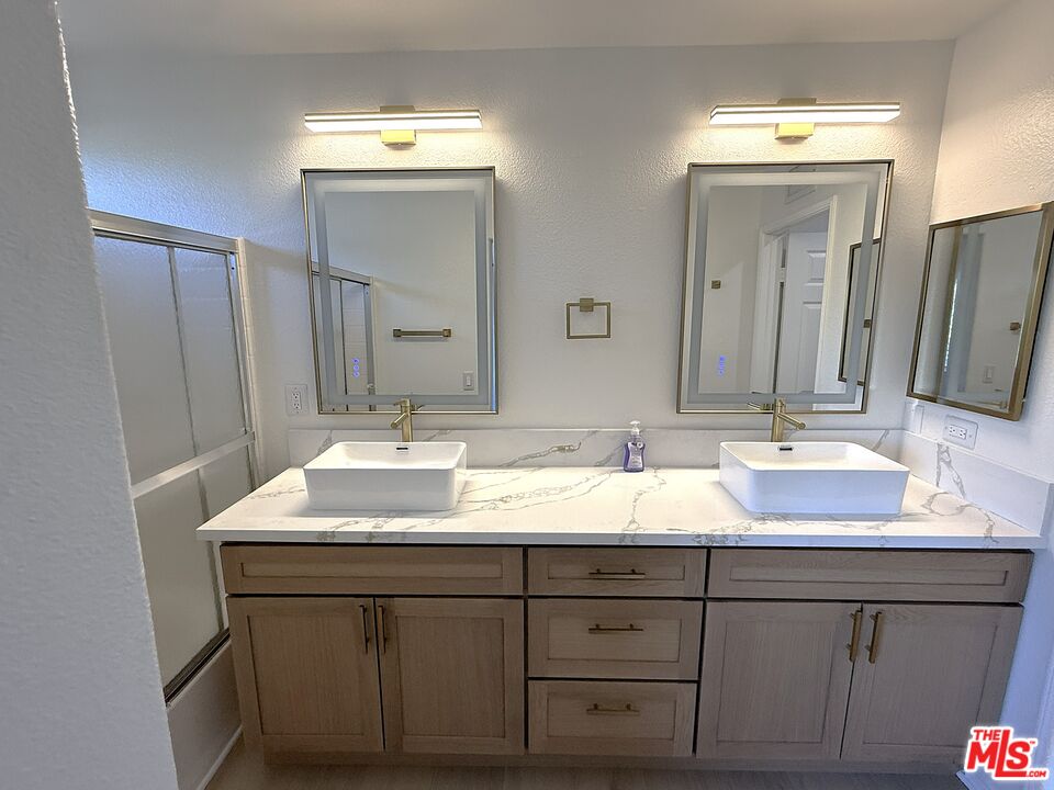 25715 Wagner Way, Unit B Stevenson Ranch, CA 91381 - Photo 24 of 24 a bathroom with double sink and a mirror