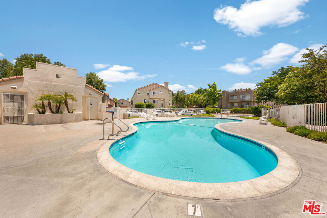 25715 Wagner Way, Unit B Stevenson Ranch, CA 91381 - Photo 6 of 24 a view of a swimming pool with a yard