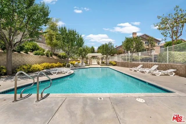 an outdoor space with swimming pool and furniture