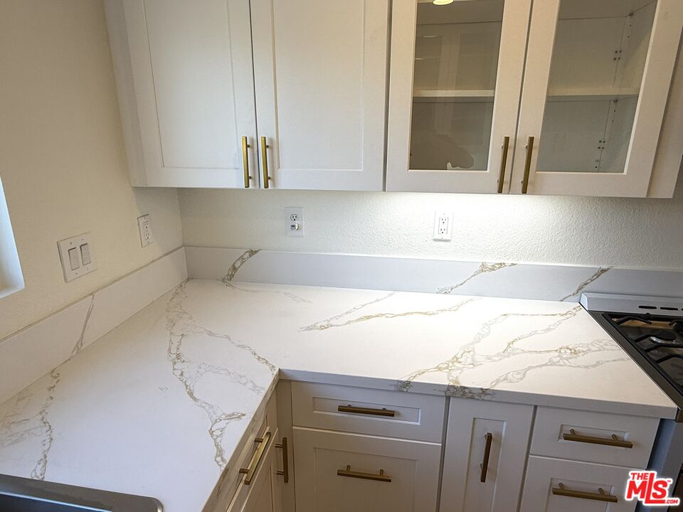 25715 Wagner Way, Unit B Stevenson Ranch, CA 91381 - Photo 9 of 24 a kitchen with a sink and cabinets