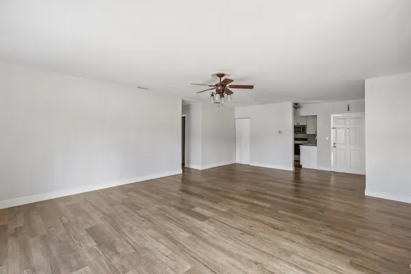 a view of a workspace with furniture and wooden floor
