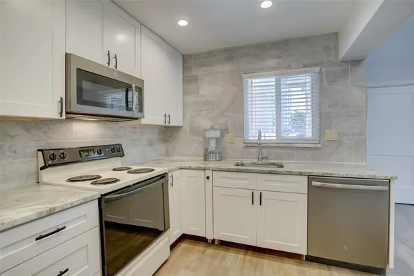 a kitchen with a refrigerator and a sink