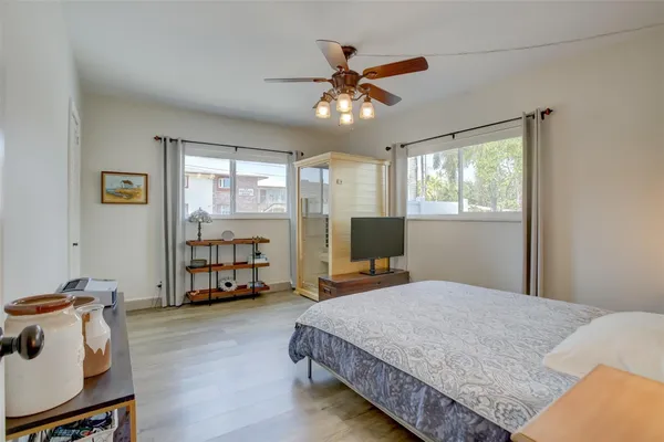 a view of a livingroom with wooden floor and a ceiling fan
