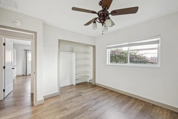 a view of a workspace with furniture and a book shelf