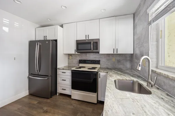 a kitchen with a refrigerator and a sink