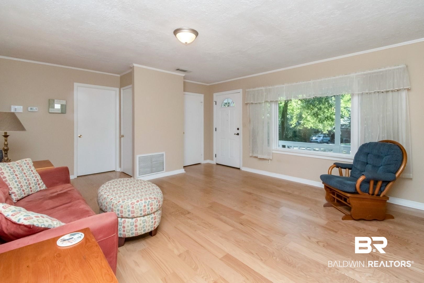 1321 Rainbow Drive West Mobile, AL 36693 - Photo 8 of 48 Living room featuring ornamental molding, a textured ceiling, and hardwood / wood-style floors