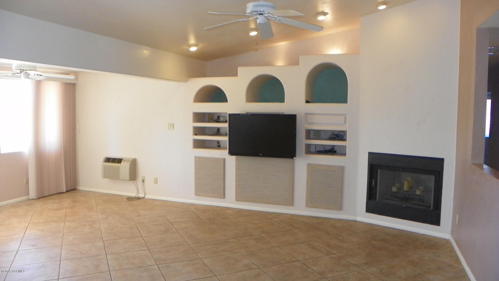 134 Ruta Camaron Rio Rico, AZ 85648 - Photo 4 of 25 a view of an empty room with a fireplace and a window