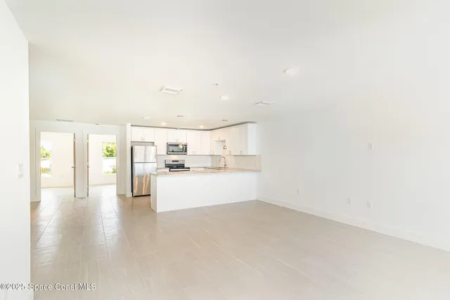 a view of a kitchen with microwave and cabinets