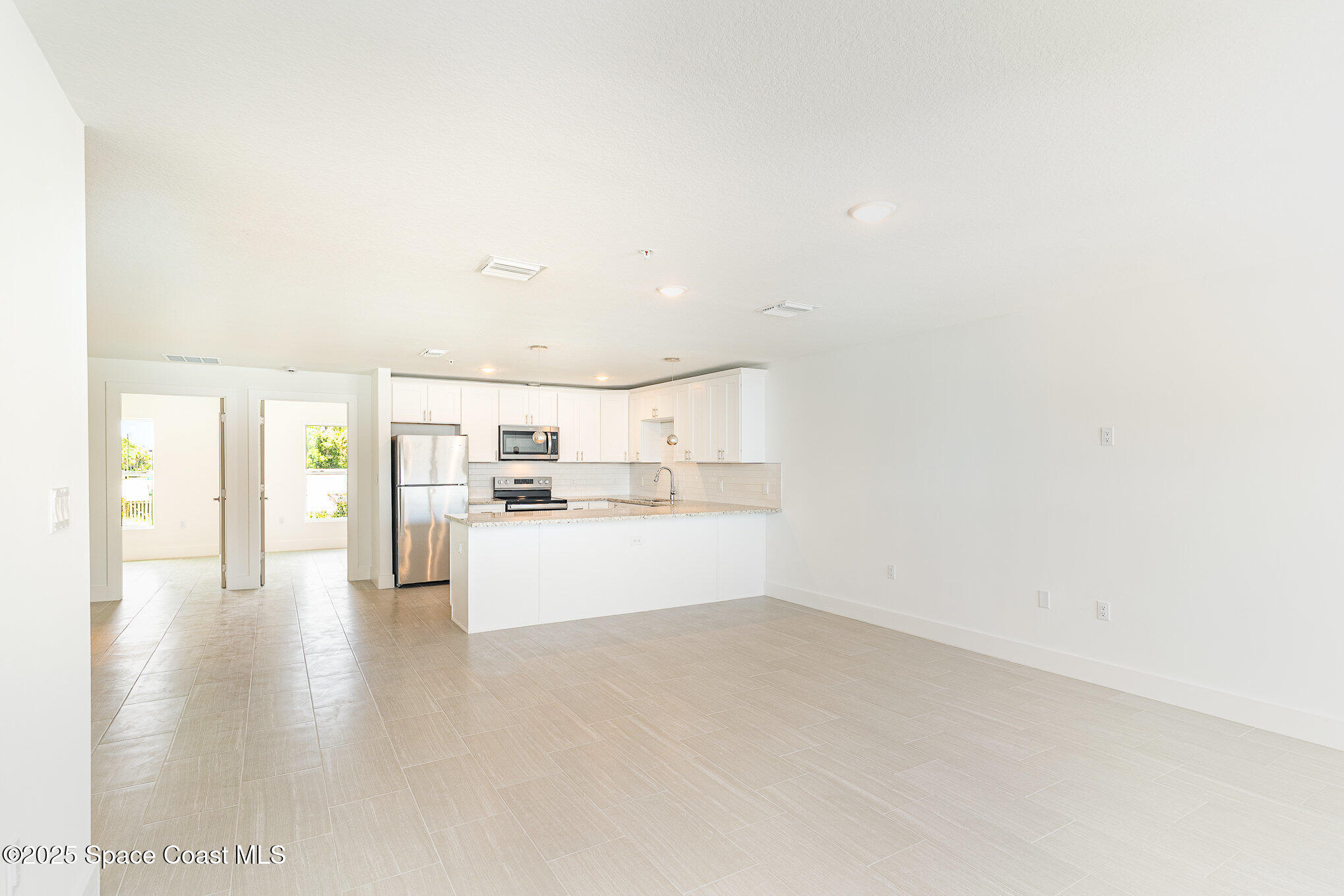 1605 Par Street Northeast, Unit 3203 Palm Bay, FL 32905 - Photo 6 of 42 a view of a kitchen with microwave and cabinets