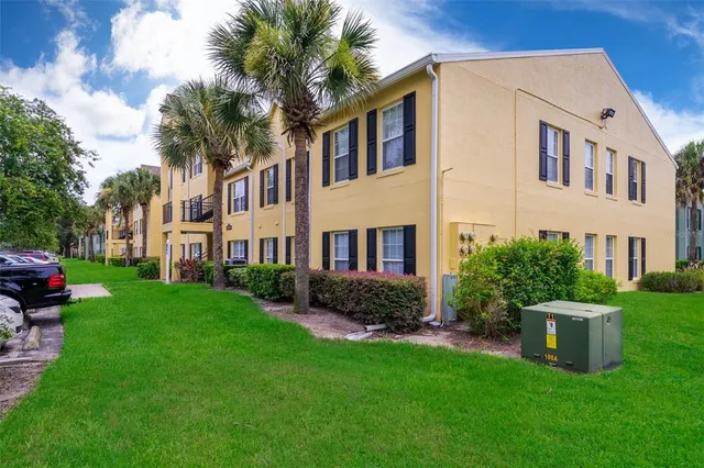 a front view of a house with a garden and trees