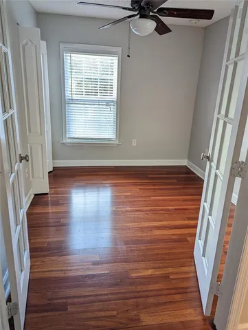 a view of a room with wooden floor and window