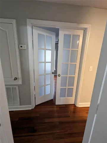 a view of front door with wooden floor