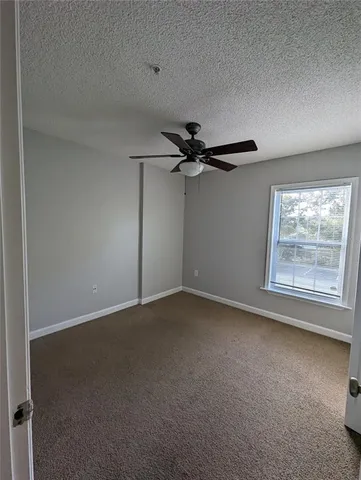 an empty room with a empty space and windows